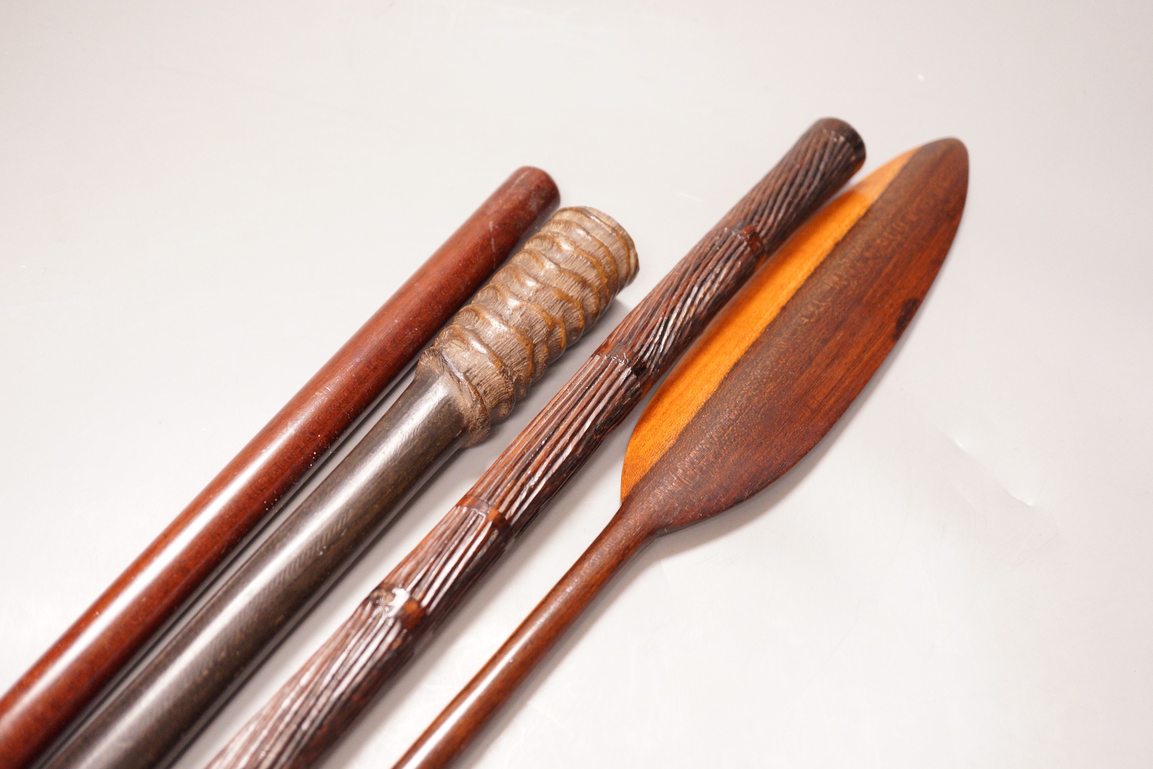 Two various hardwood canes, an ebony spear and a horn tool, longest 111cm